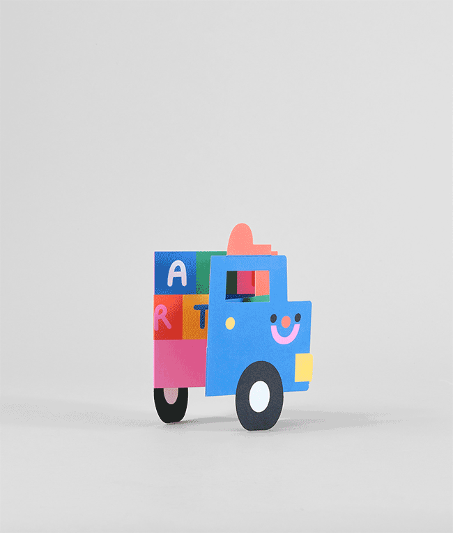 Side view of fold-out truck birthday card with vibrant colours, smiling truck cab, and playful block letters in the trailer section.