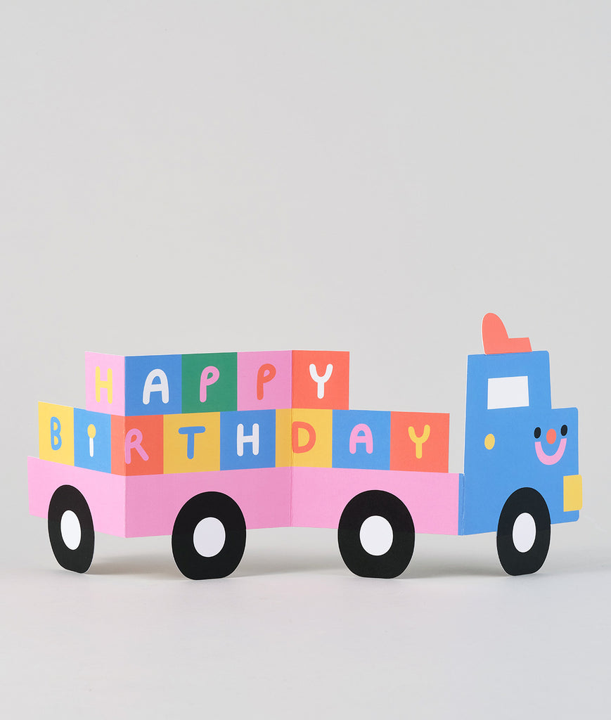 Fully visible fold-out truck card in mid-fold, with stacked birthday blocks and bold, cheerful colours perfect for a kid’s celebration.
