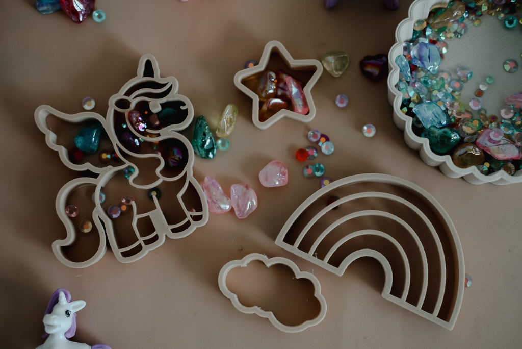 Close-up of magical playdough scene with Kinfolk Pantry unicorn cutters and pastel decorations.