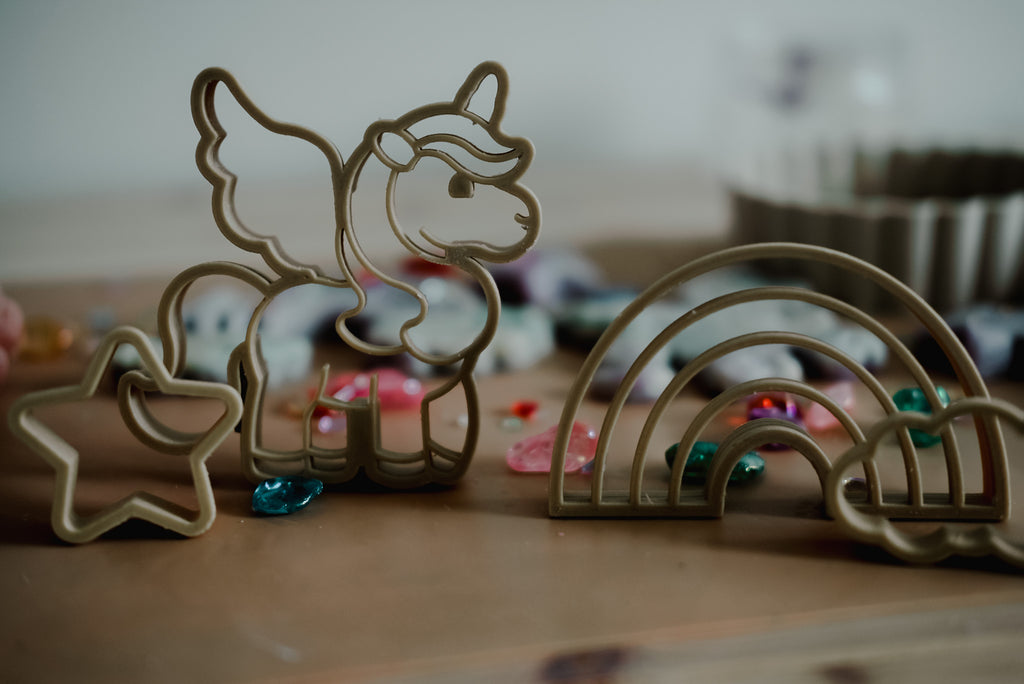 Close-up of magical playdough scene with Kinfolk Pantry unicorn cutters and pastel decorations.