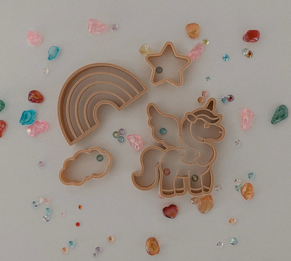 Kinfolk Pantry eco unicorn-themed cutters styled with glitter stars and rainbow shapes for imaginative play.
