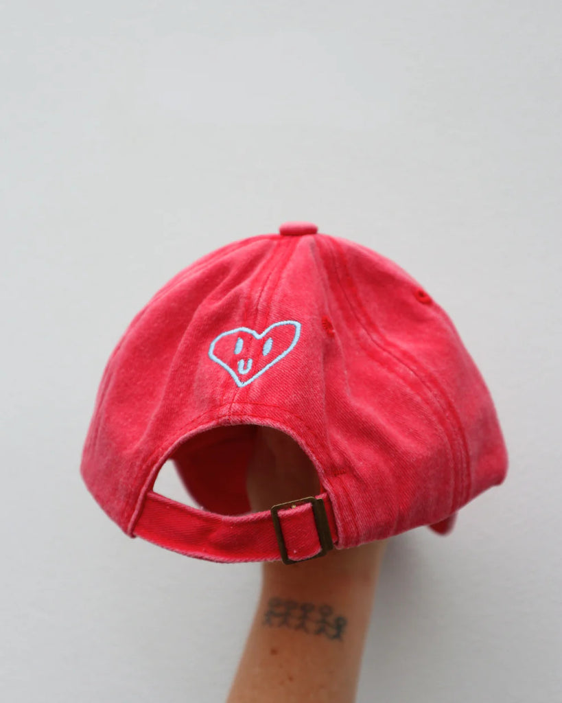 Back view of the watermelon red kids cap showing heart embroidery and adjustable strap, designed to fit children aged 1 to 7 comfortably.