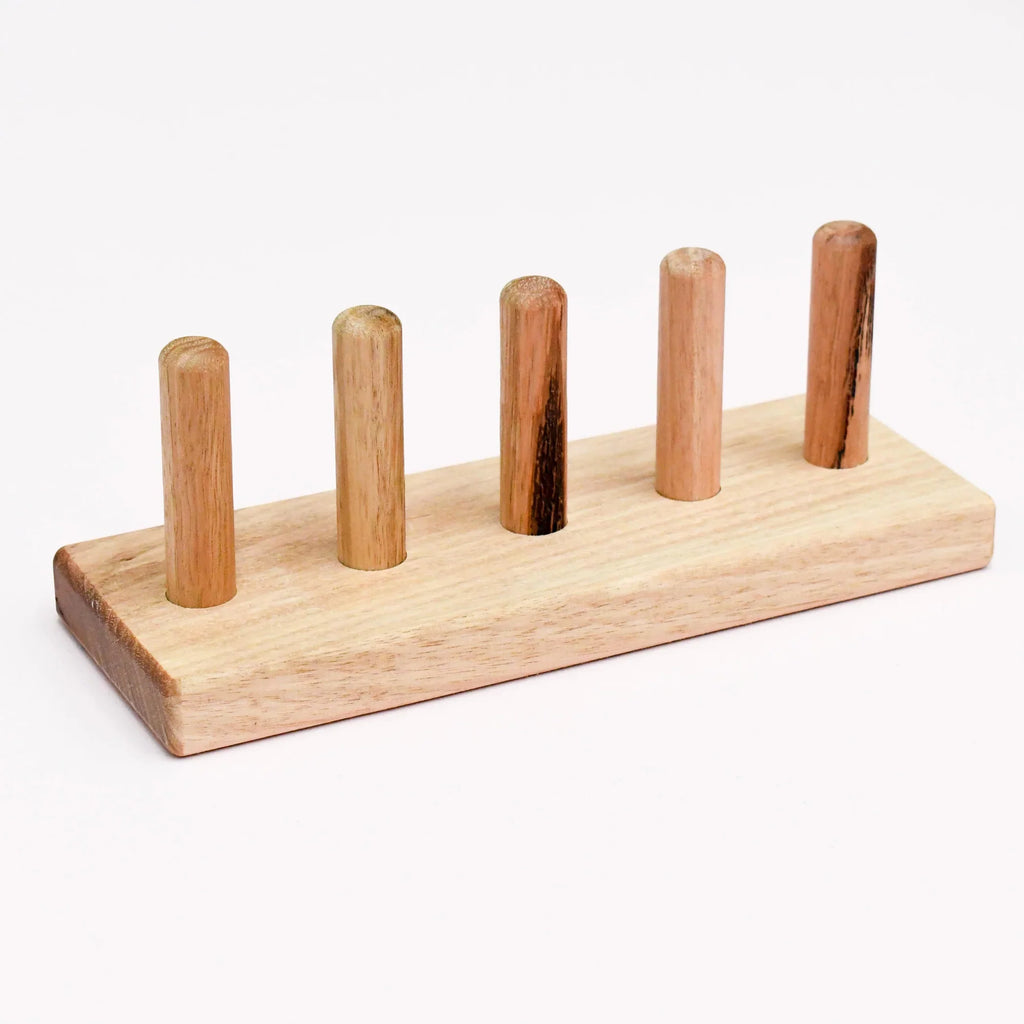 Wooden finger puppet stand made from Australian hardwood with 5 vertical slots, used to display or sort finger puppets and stacking toys.
