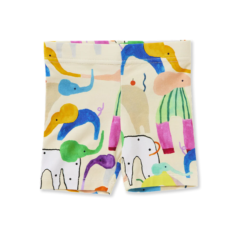 Flat lay of Halcyon Nights Happy Herd Kids Bike Shorts featuring colourful abstract animal print on a light background, made from organic cotton.