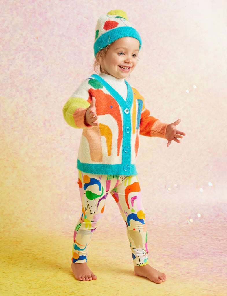 Child styled in Halcyon Nights Happy Herd leggings with a bright cardigan and beanie.