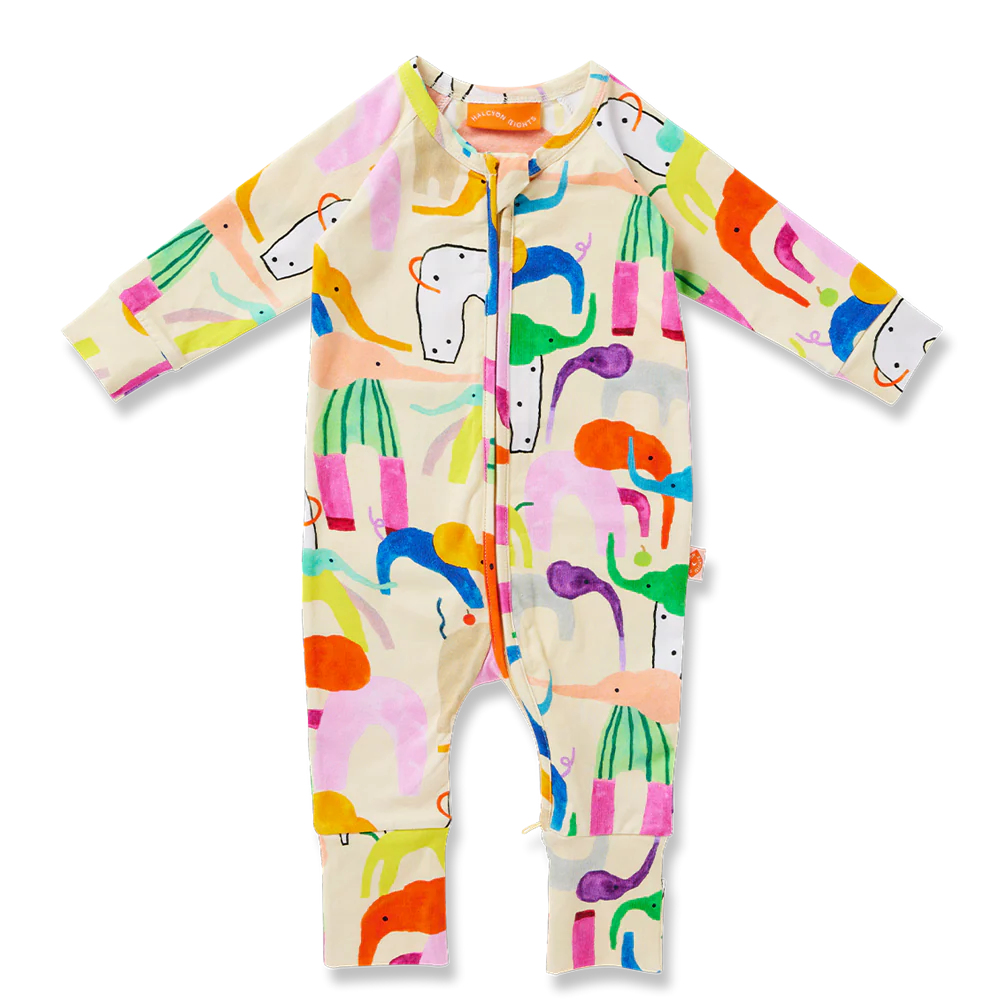 Flat lay of Halcyon Nights Happy Herd long sleeve romper featuring a playful all-over animal print in bright pastel colours on cream background.