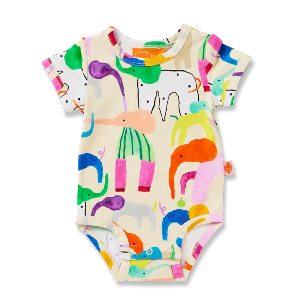 Flat lay of Halcyon Nights Happy Herd short sleeve baby bodysuit, featuring a cream base with vibrant, colourful animal illustrations all over.